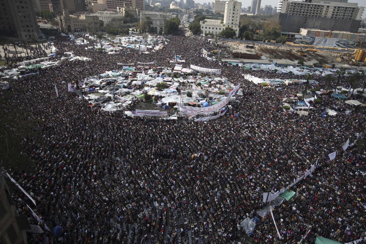 Antigovernment protesters perform the Muslim Friday prayers in Cairo in February 2011.