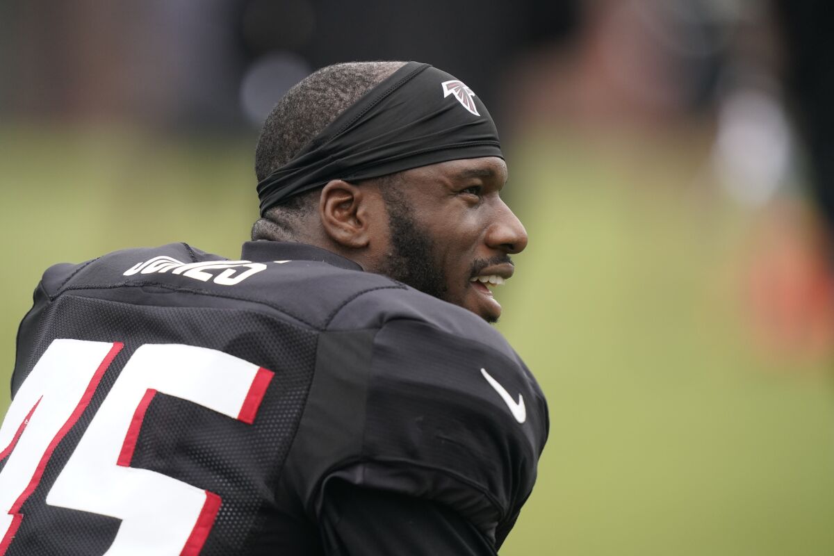 Atlanta Falcons linebacker Deion Jones (45) talks with other players during NFL football practice on Tuesday, Aug. 3, 2021, in Flowery Branch, Ga. (AP Photo/Brynn Anderson)