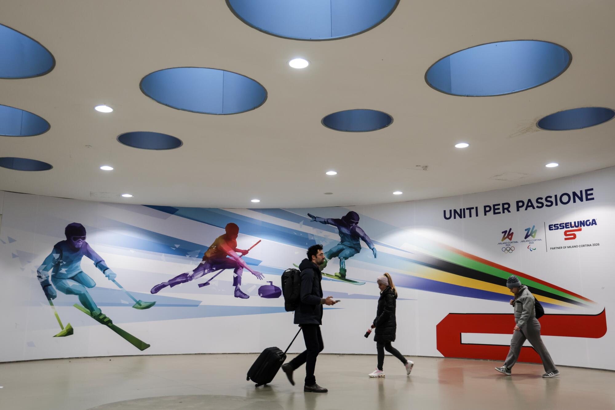 Travelers pass through the lobby of Milan Linate Airport M4 Metroline train station