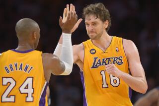 Los Angeles Lakers guard Kobe Bryant, left, is congratulated by forward Pau Gasol.