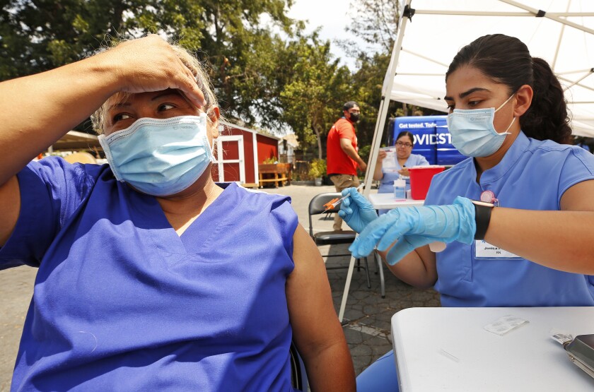 Auxiliadora Gutierrez, 55, gets a COVID vaccination.