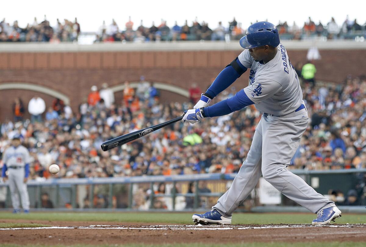 Carl Crawford hits an-RBI single as part of a four-run first inning for the Dodgers against the San Francisco Giants on Saturday night.