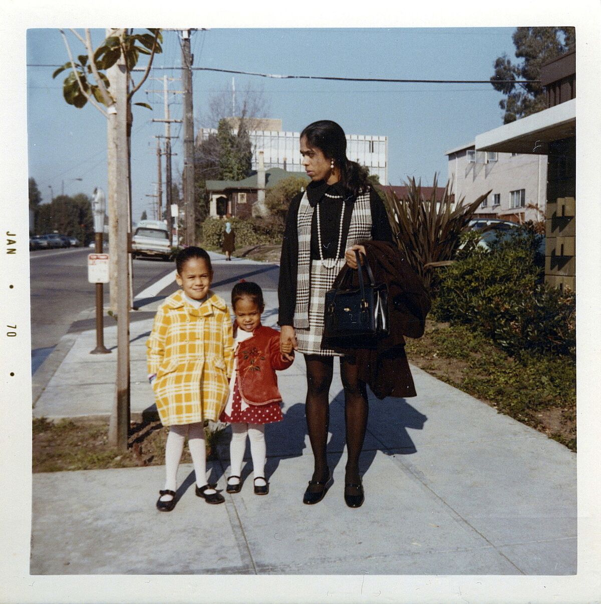 This January 1970 photo shows her, left, with her sister, Maya, and mother, Shyamala, outside their apartment in Berkeley.
