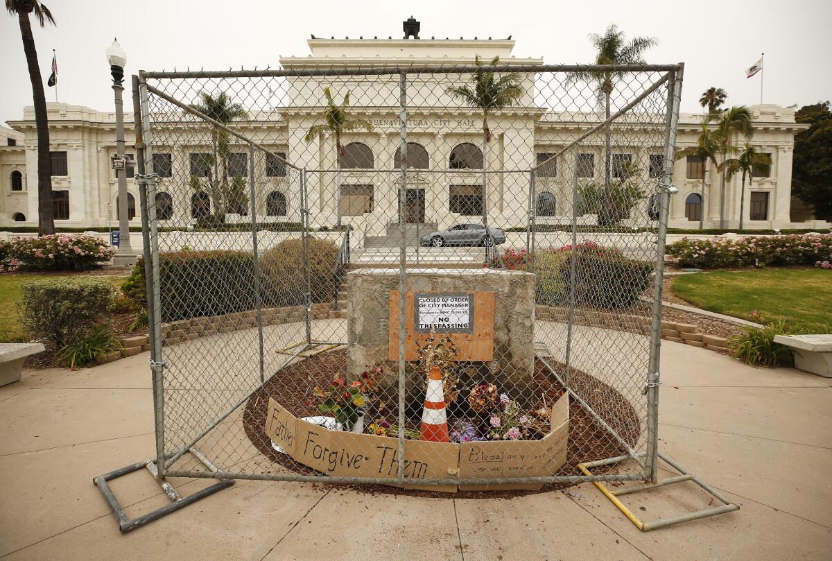 A stand that held a statue of Junipero Serra before it was removed in 2020 is protected by fencing at Ventura City Hall 