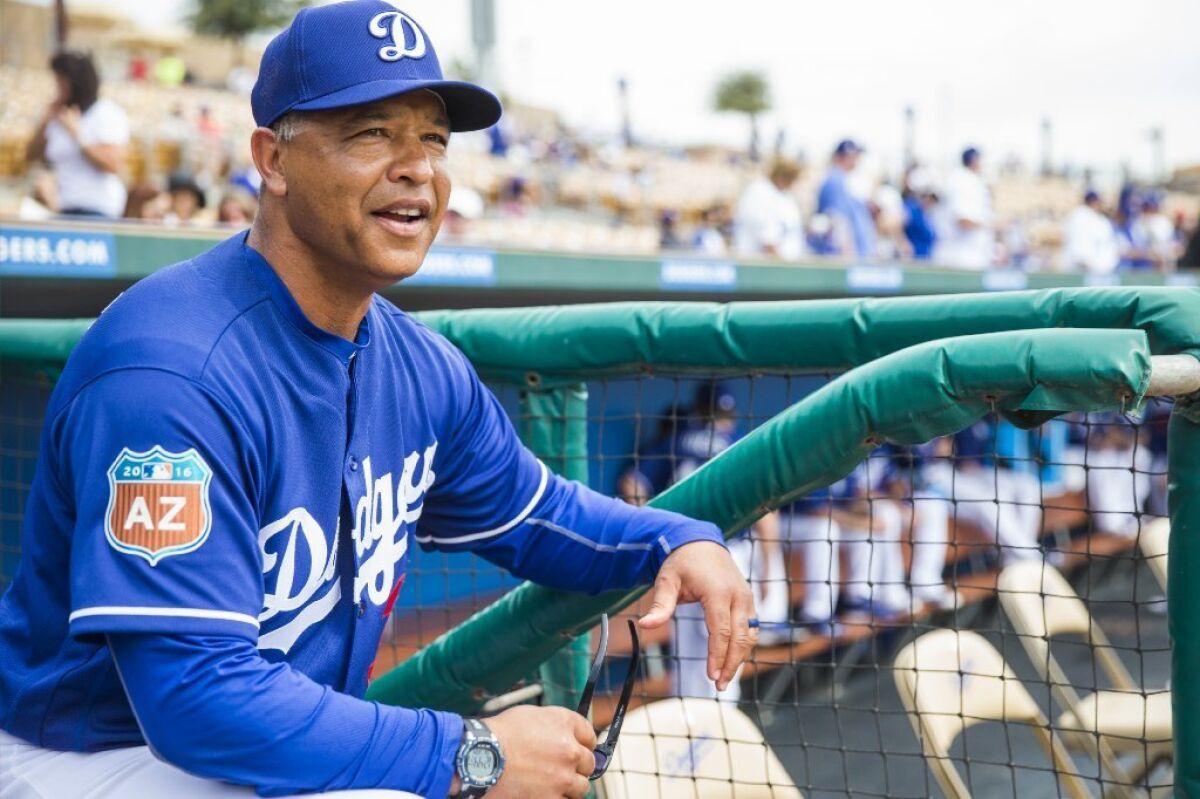 Dodgers Manager Dave Roberts looks on from the dugout during a spring training game against the Chicago White Sox on March 3.