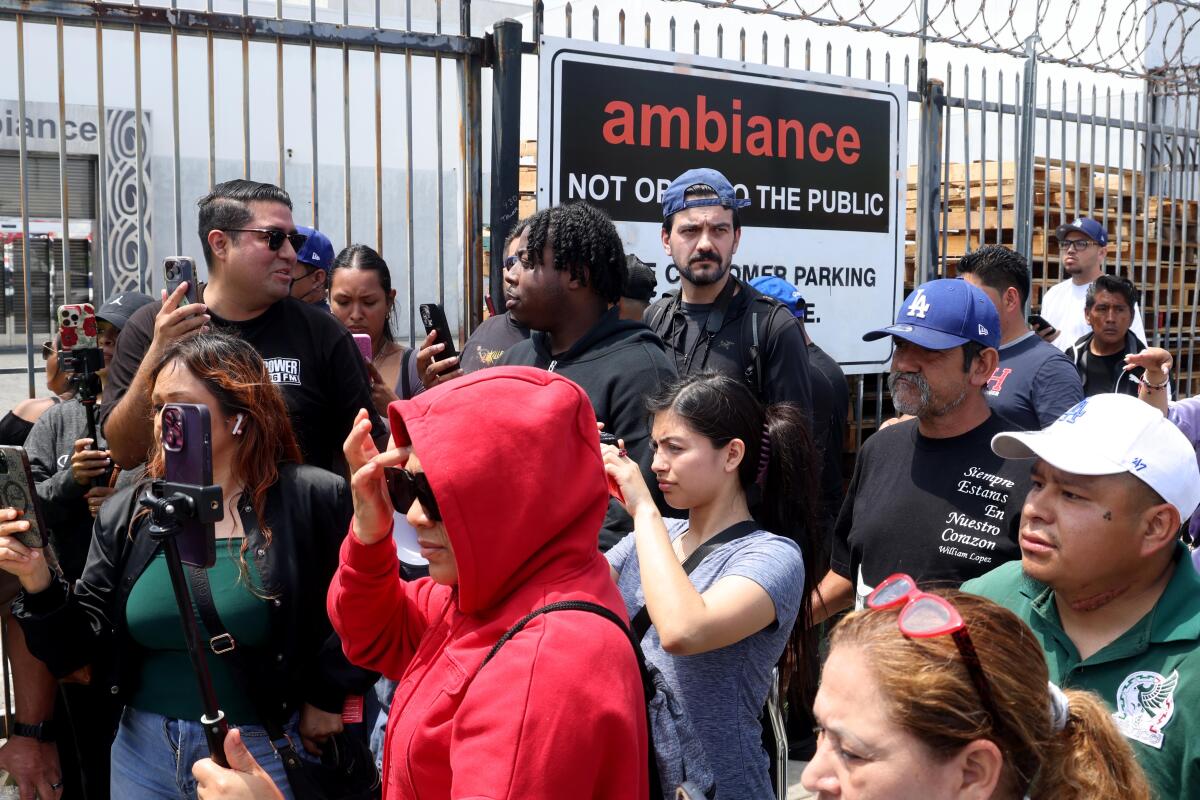 People gathered in the atmosphere clothing after federal agents took several employees away.