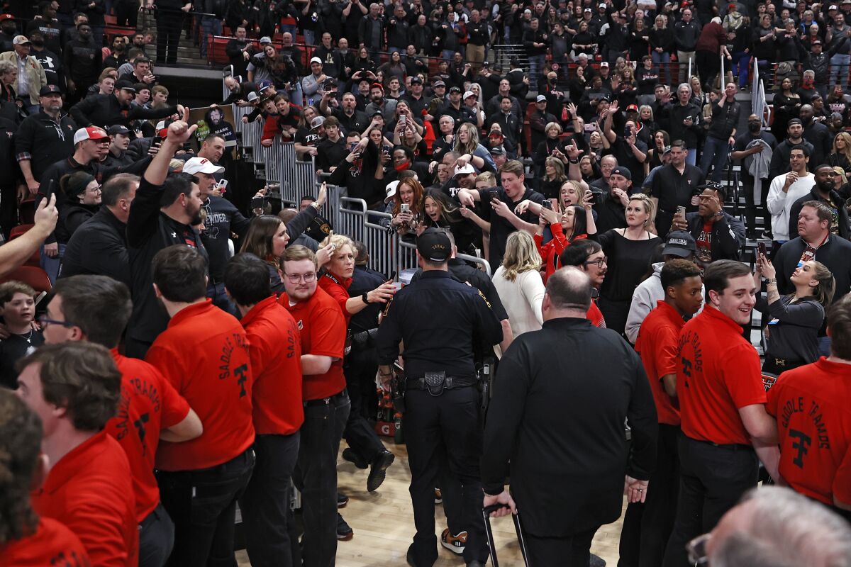 Texas Tech fans yell at Texas coach Chris Beard as he walks off the court after an NCAA college basketball game Tuesday, Feb. 1, 2022, in Lubbock, Texas. (AP Photo/Brad Tollefson)