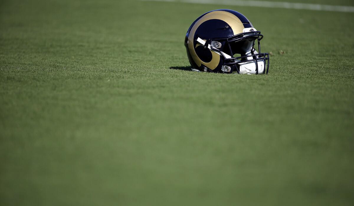 A Rams helmet sits on the turf during training camp at the NFL football team's practice facility. 