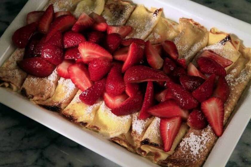 Quark is used in creamy cheese crepes with fresh berries.