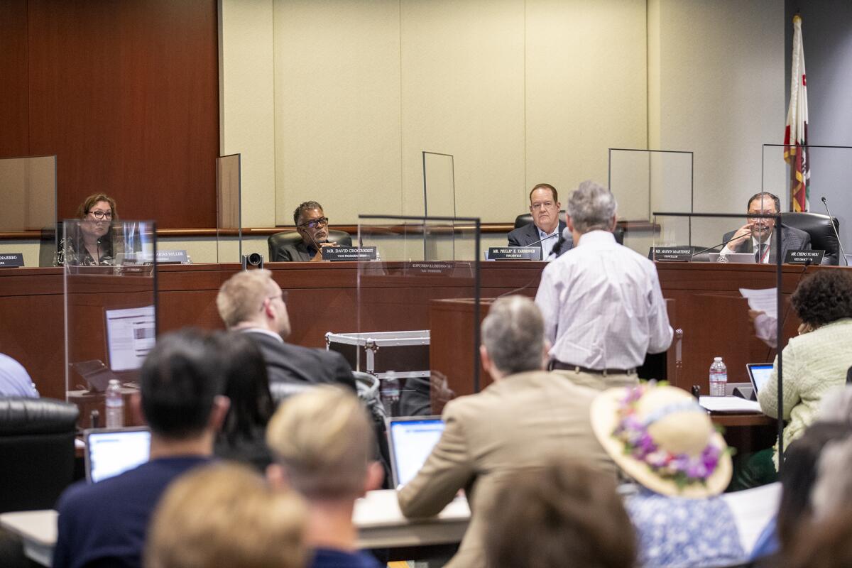 A Rancho Santiago Community College District retiree speaks to board members during a meeting on Monday, April 25.