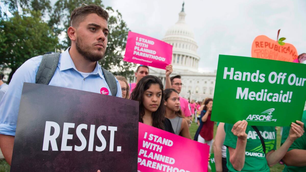 Supporters of Planned Parenthood demonstrate against healthcare legislation proposed by Senate Republicans. (Saul Loeb / AFP-Getty Images)
