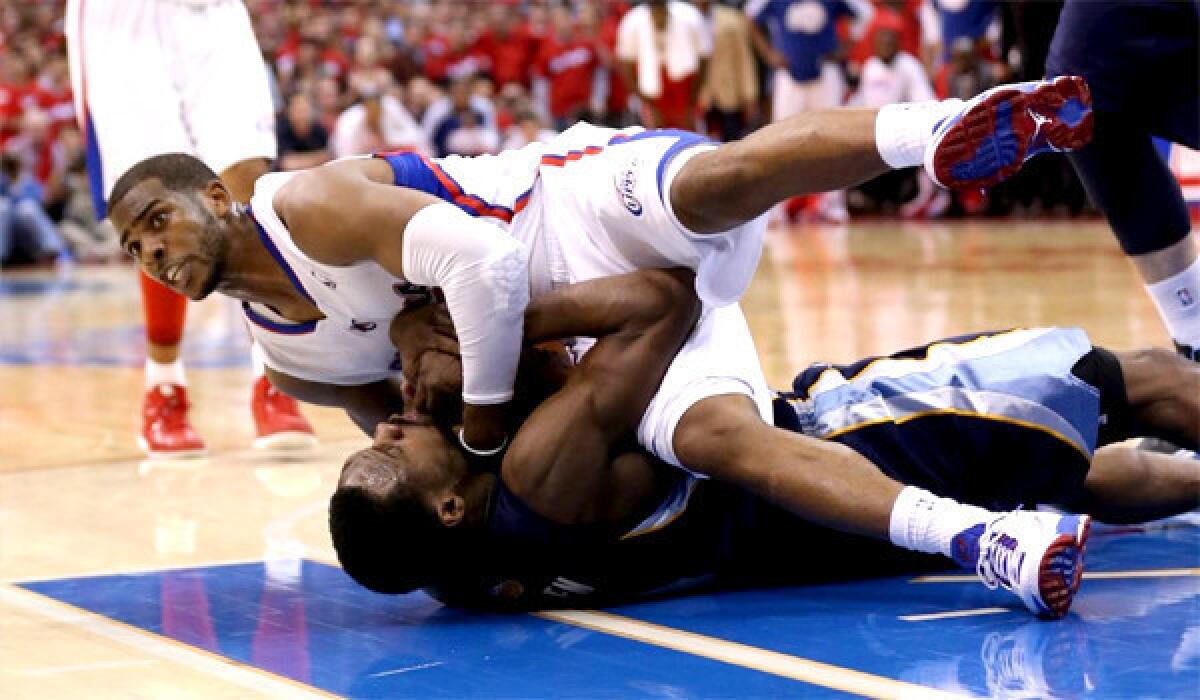 Chris Paul and Tony Allen get tied up fighting for possession of the ball during the Clippers' victory over the Memphis Grizzlies, 93-91, to grab a 2-0 lead in the series.