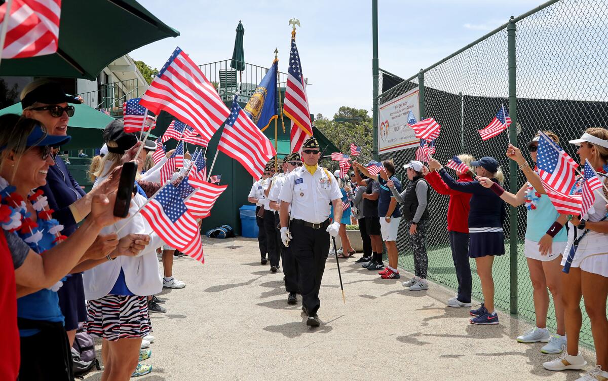 Members of Newport Harbor Post 291 of the American Legion color guard march to center court during Saturday's ceremony.