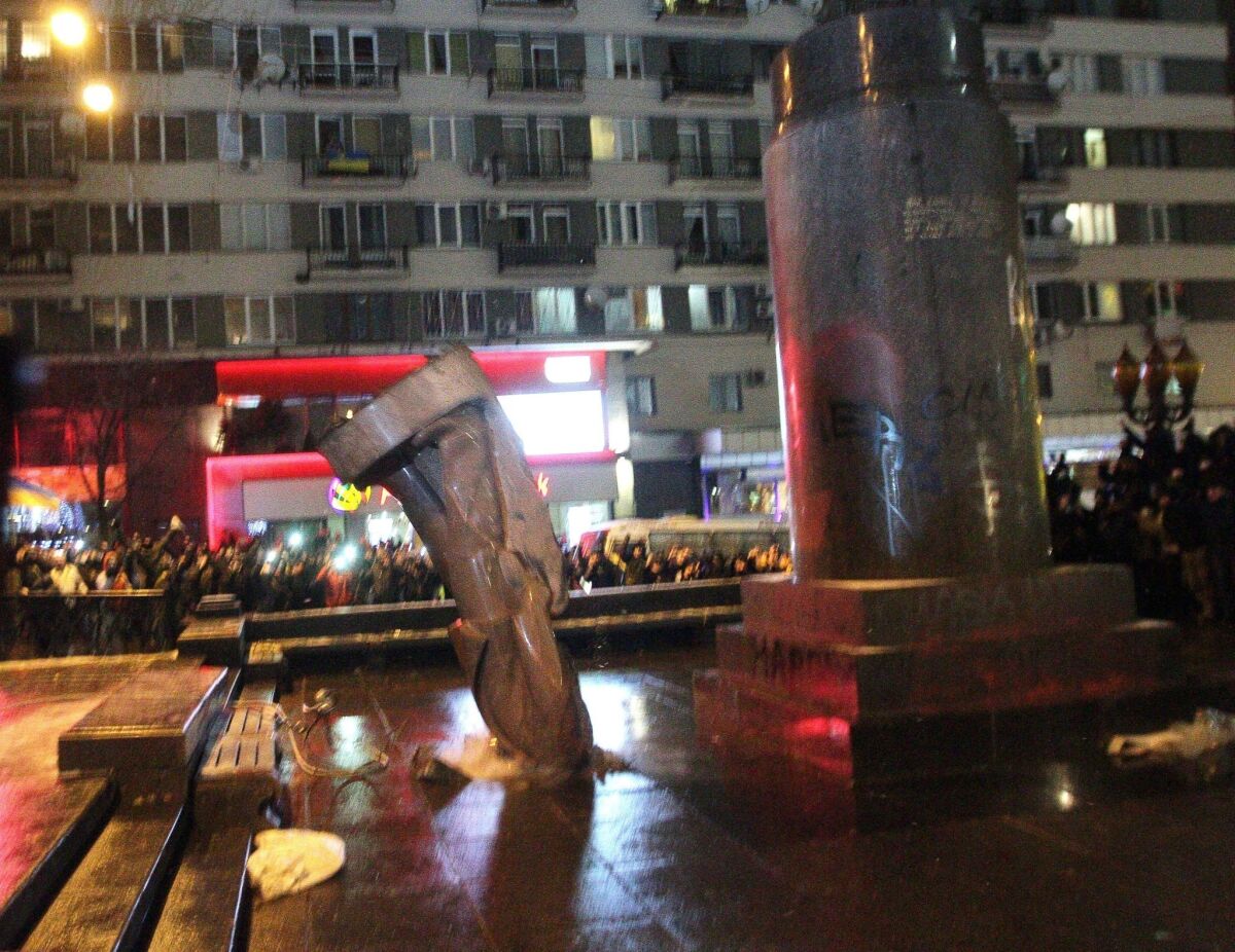Ukrainian opposition protesters have focused their wrath over an abandoned association agreement with the European Union on symbols of Soviet-era domination of Ukraine. On Sunday, protesters toppled a statue of Soviet founder Vladimir Lenin from its pedestal in Kiev.