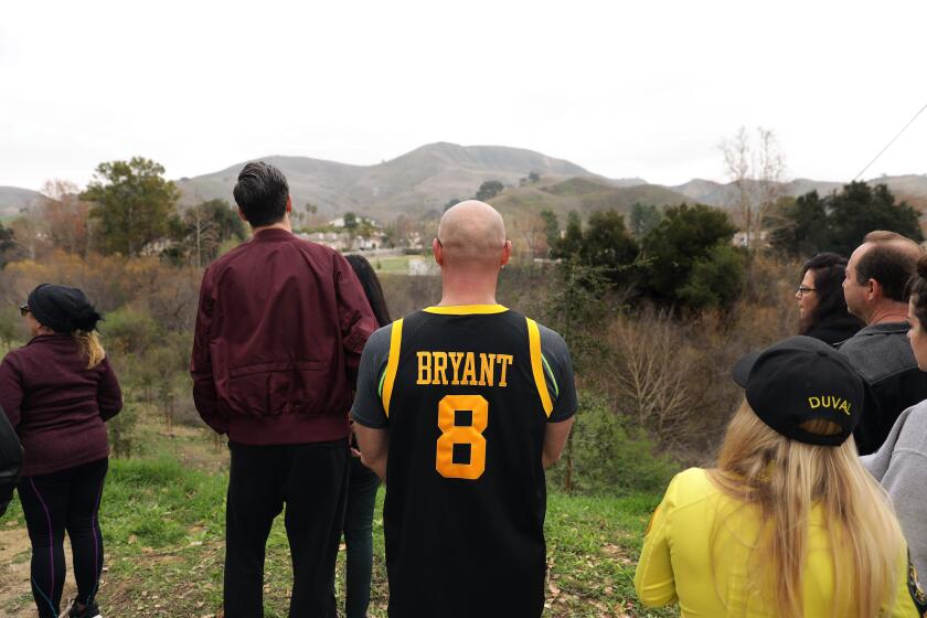 CALABASAS-CA-JANUARY 26, 2020: Fans, including Gennady Grinblat, center, gather in Calabasas after reports that Kobe Bryant died in a helicopter crash. (Christina House / Los Angeles Times)