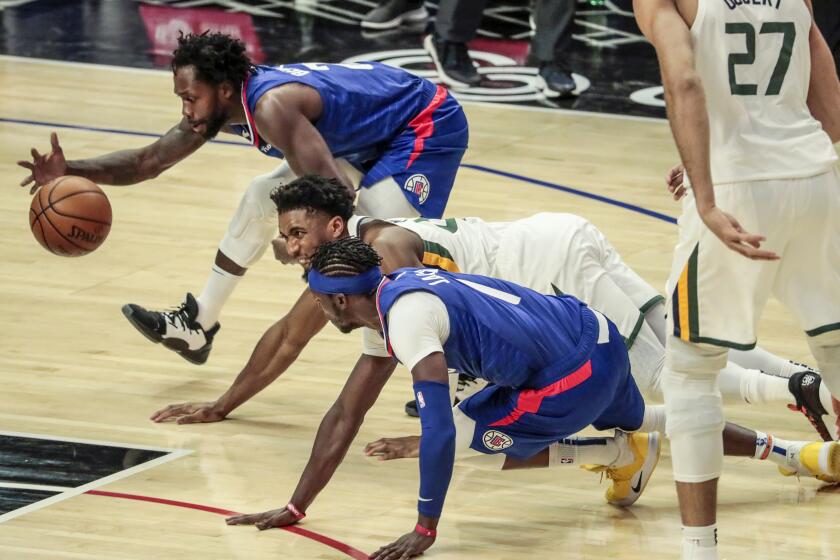 Los Angeles, CA, Wednesday, February 17, 2021 - LA Clippers guard Reggie Jackson (1) fouls Utah Jazz guard Donovan Mitchell (45) as LA Clippers guard Patrick Beverley (21) chases the loose ball during first quarter action at Staples Center. (Robert Gauthier/Los Angeles Times)
