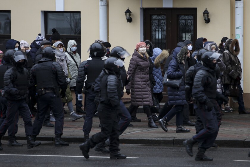 Riot police block Belarusian pensioners wearing face masks to protect against coronavirus during an opposition rally to protest the official presidential election results in Minsk, Belarus, Monday, Nov. 30, 2020. Hundreds of retirees rallied in the Belarusian capital on Monday against the country's authoritarian leader, as security forces moved to break up the traditional weekly march. The crowd of pensioners in Minsk that demanded President Alexander Lukashenko to resign ran into police cordons along the route of the march and divided into smaller groups that went into different directions. (AP Photo)