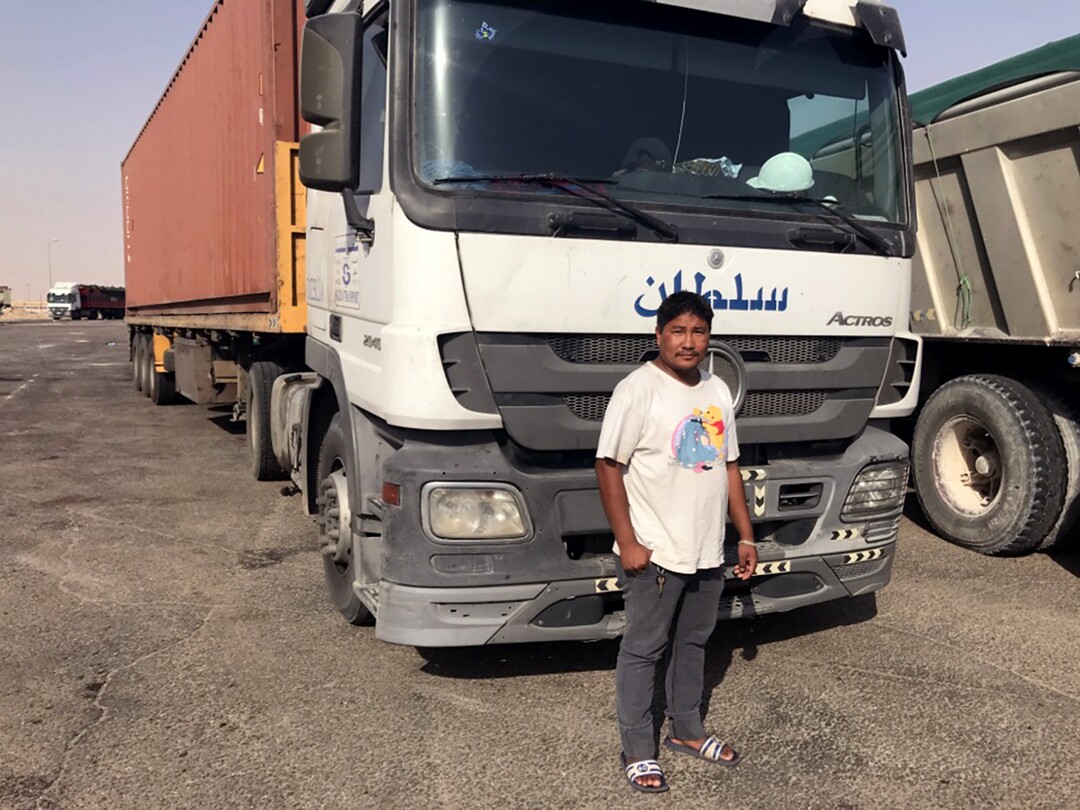 Bhawindra Tamang, another of Subash's nephews, pictured next to his truck at a rest stop outside Dammam, Saudi Arabia.