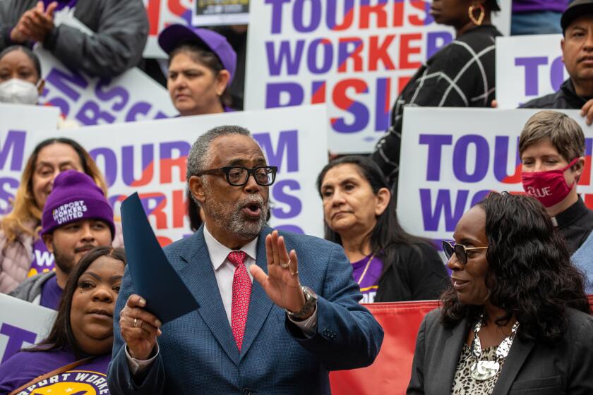 LOS ANGELES, CA - APRIL 12: Los Angeles City Councilmember Curren Price, center, applauds Yvonne Wheeler, President, LA County Federation of Labor after she spoke on support of a motion introduced by Price to raise the wages for tourism workers to $25 an hour and fix loopholes in current policies to keep workers healthy and housed. Councilman Price and unions SEIU United Service Workers West and UNITE HERE Local 11at press conference held on the steps of City Hall on Wednesday, April 12, 2023 in Los Angeles, CA. (Irfan Khan / Los Angeles Times)