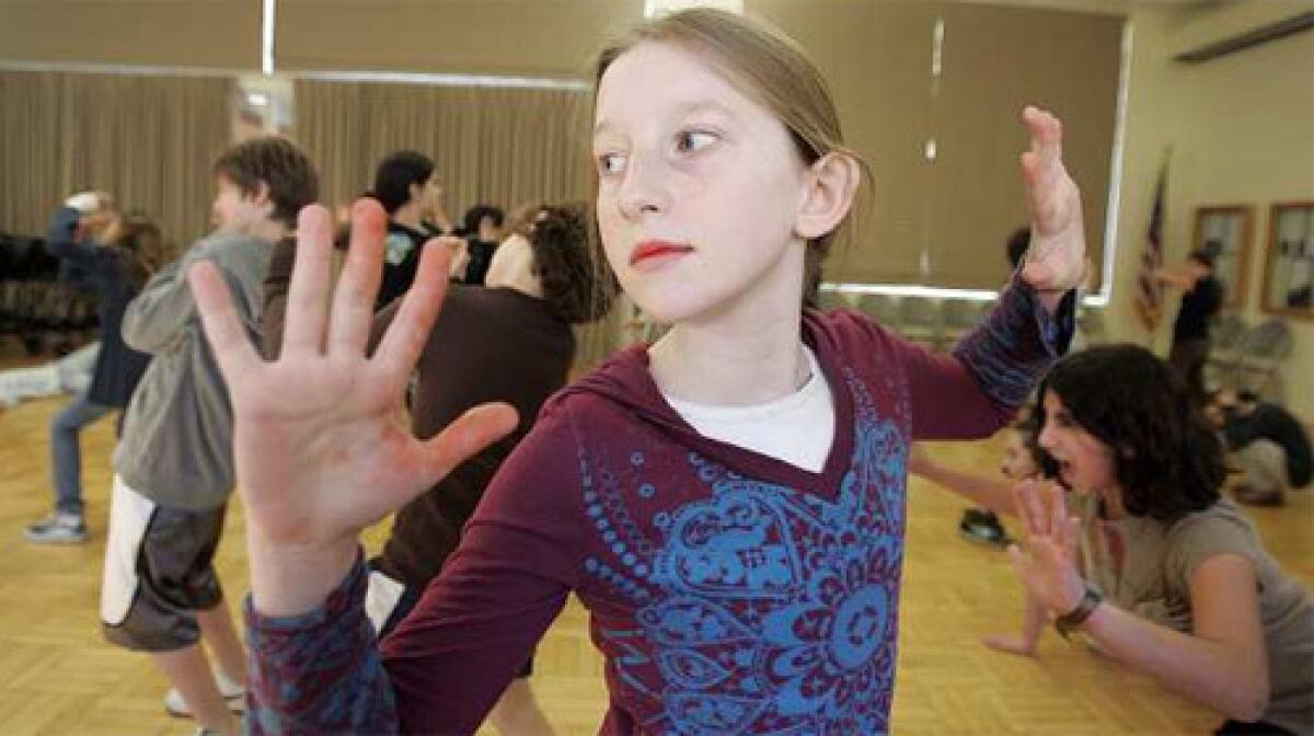 BODIES IN MOTION: Macauley Aseon-Nielsen, 11, participates in a combined physics lesson and dance session at Corinne A. Seeds University Elementary School on the UCLA campus.