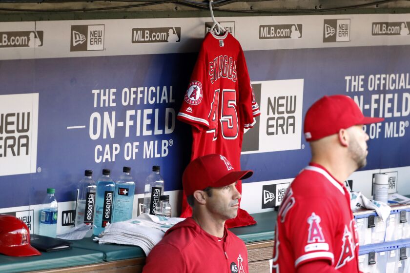 Los Angeles Angels manager Brad Ausmus sits on the bench in front of the jersey of Tyler Skaggs during a baseball game against the Texas Rangers in Arlington, Texas, Tuesday, July 2, 2019. (AP Photo/Tony Gutierrez)