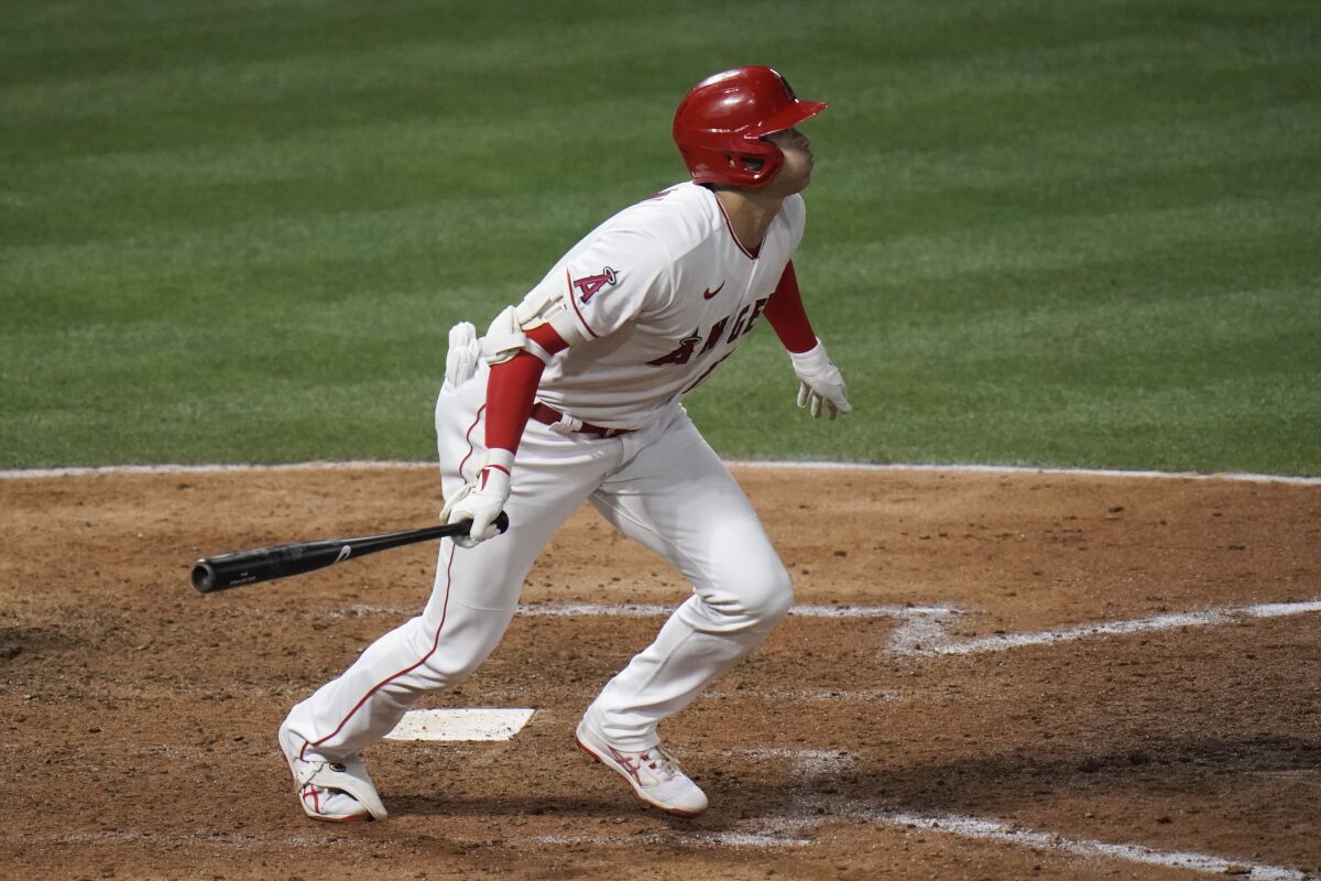 Angels designated hitter Shohei Ohtani hits a run-scoring double in the sixth inning.