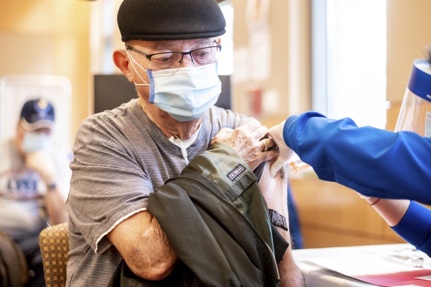 Jim Clark, 86, receives a first dose of Pfizer-BioNTech COVID-19 vaccine in Sacramento.