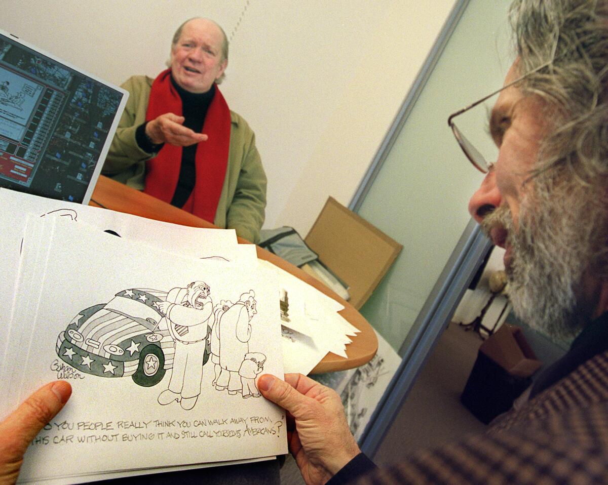 Cartoonist Gahan Wilson, left, waits for New Yorker cartoon editor Robert Mankoff to assess his offerings at the magazine's offices in 2001.