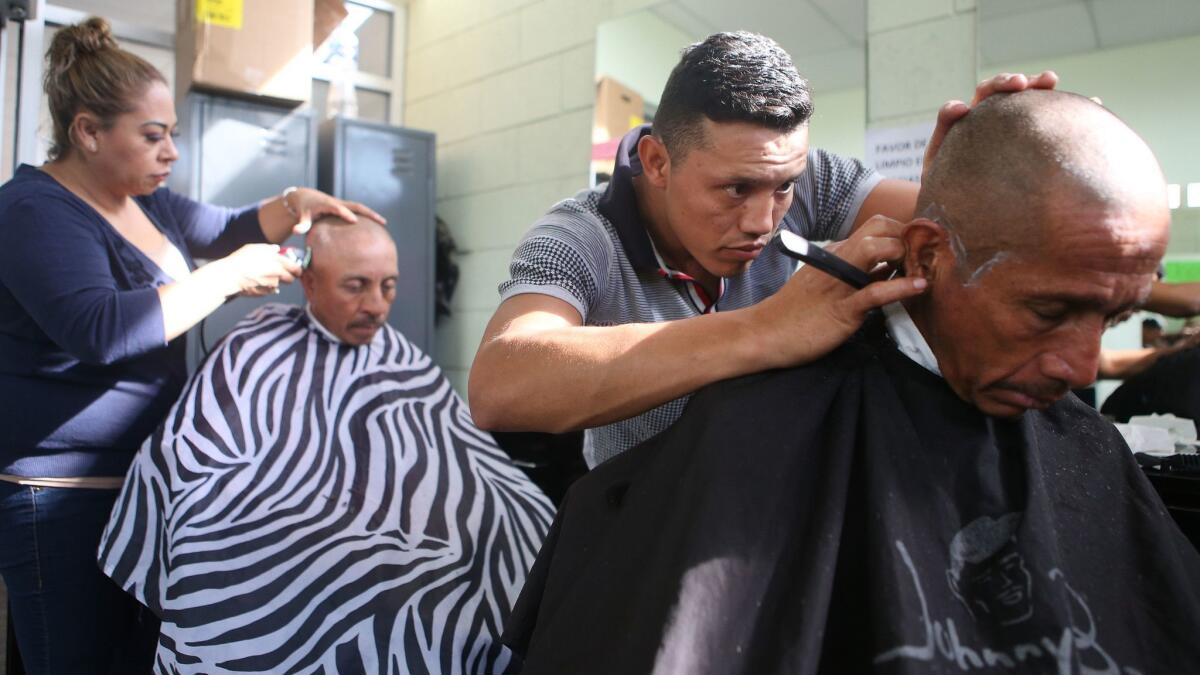 Deportees get haircuts at a migrant shelter near the U.S. border.