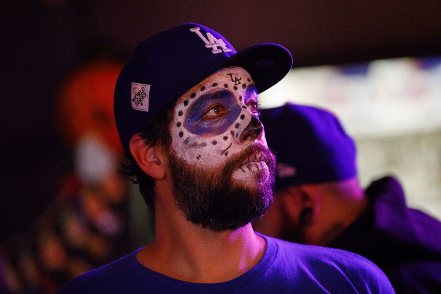 Bartender Nate Joyner wears face paint as he watches the game with Dodgers fans at the Down N Out bar in downtown Los Angeles.