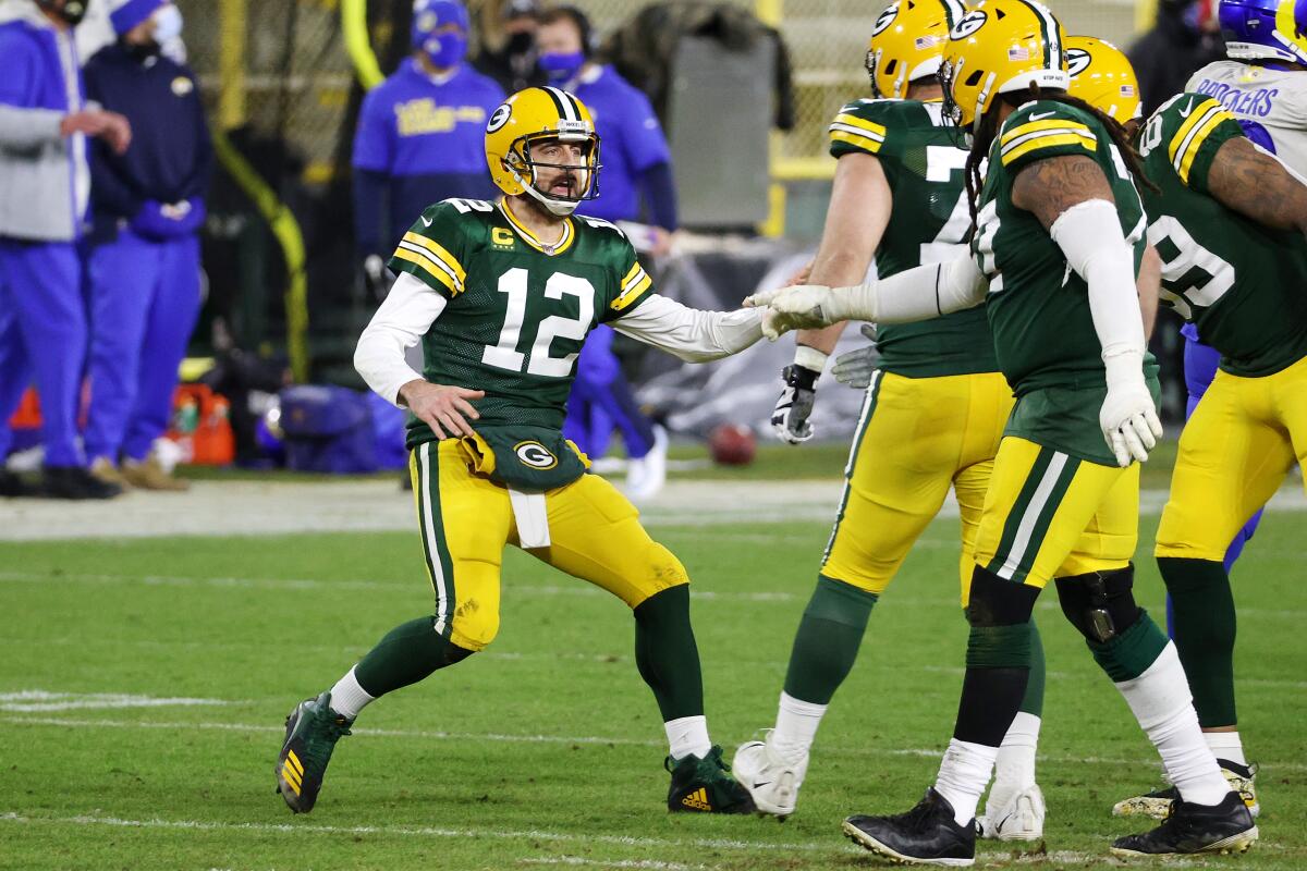 Aaron Rodgers of the Green Bay Packers celebrates throwing a touchdown pass in fourth quarter.