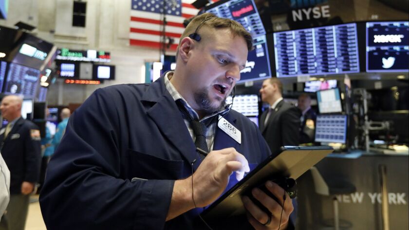 Trader Michael Milano works on the floor of the New York Stock Exchange.