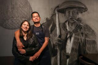 LONG BEACH, CA - FEBRUARY 6, 2024 - - Daiwa Wong and her husband Eduardo Chang, owners and operators of Sushi Nikkei, stand next to a mural, created by artist Rudolph Castro, inside the restaurant in the Bixby Knolls neighborhood of Long Beach on February 6, 2024. Sushi Nikkei is a Peruvian Style sushi restaurant. (Genaro Molina/Los Angeles Times)
