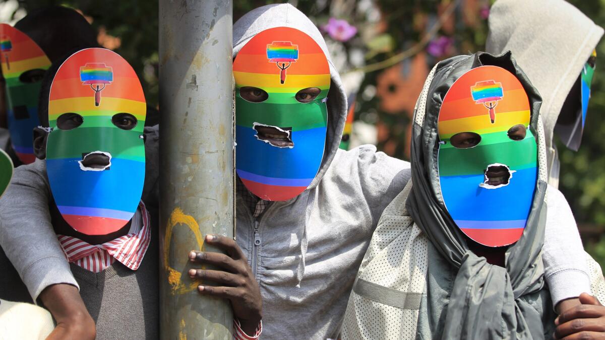 Masked Kenyan supporters of the LGBT community stage a protest against Uganda's anti-gay bill in Nairobi. Ugandan President Yoweri Museveni has been warned by President Obama that signing an anti-gay law would "complicate" the U.S. relationship with the east African country.