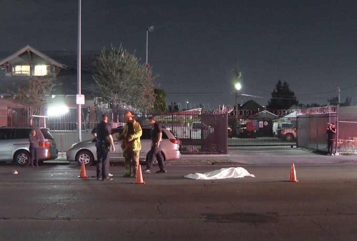 LAPD investigate the scene where a body was found at E. Vernon and Towne Avenues in Los Angeles.