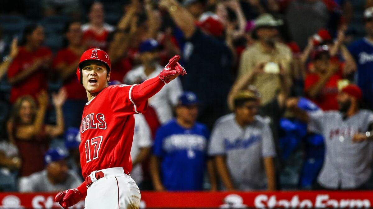 Angels designated hitter Shohei Ohtani (17) gestures after scoring to tie the game late in the ninth inning against the Los Angeles Dodgers.