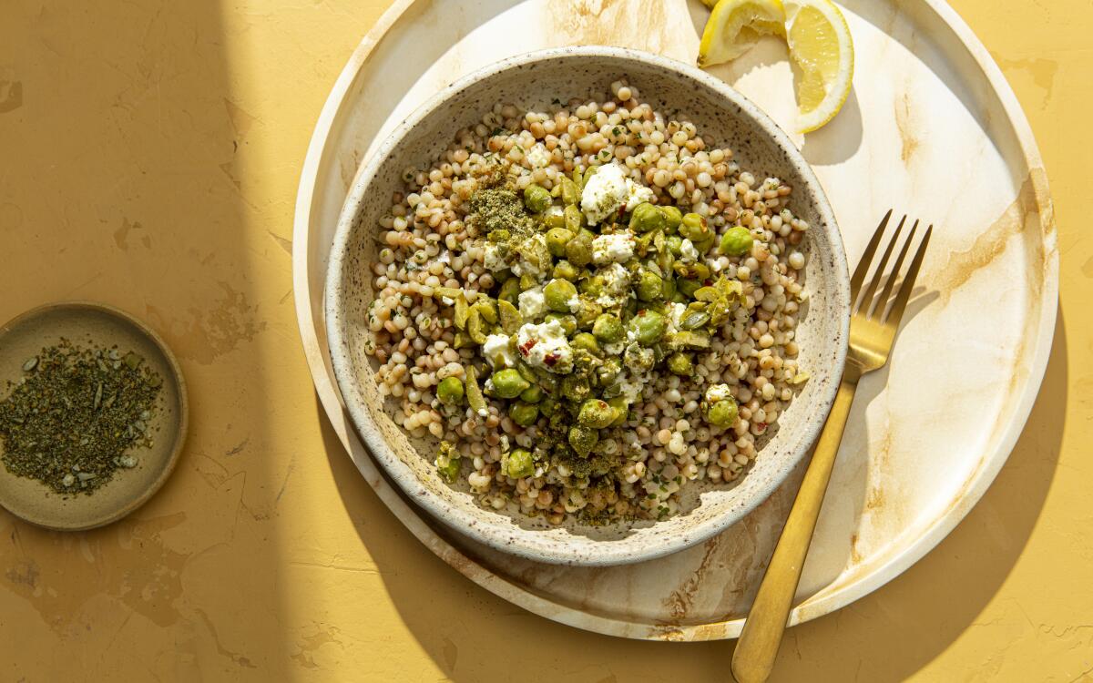 A blend of za'atar and ground pepitas showered over couscous and fresh garbanzo beans mixed with feta and green olives.
