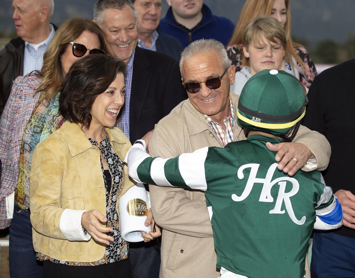 Combatant co-owners Stephanie and Kosta Hronis celebrate with jockey Joel Rosario after their victory in the $600,000 Santa Anita Handicap on March 7, 2020, at Santa Anita Park.