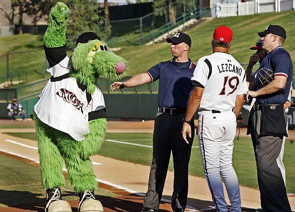 Thunder, one of 11 mascots of minor league baseball team Lake Elsinore Storm, entertains spectators at Diamond Stadium during the managers' meeting at home plate.