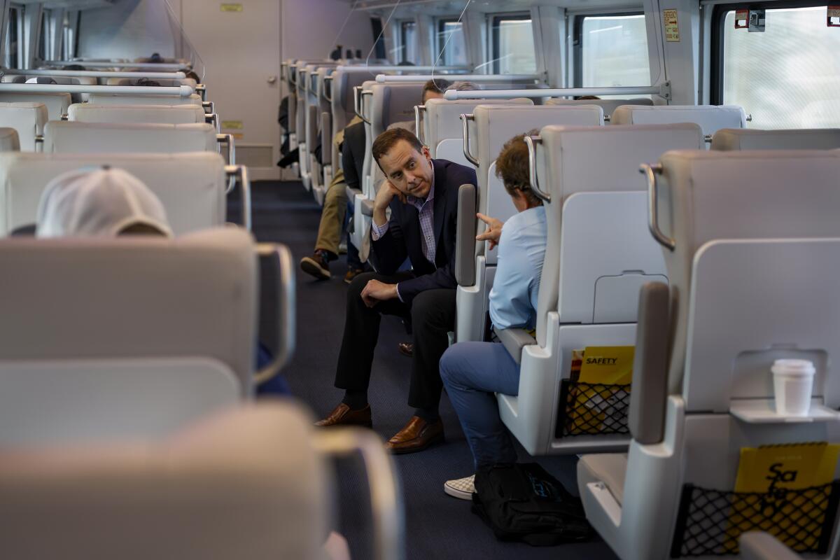 Passengers travel onboard the smart coach of a Brightline train in 