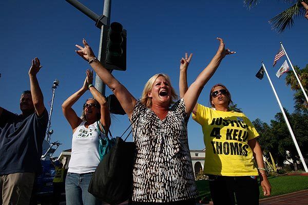 Members of Kelly's Army chant "two down four to go" outside the Fullerton Police Department after two officers were charged in connection with the death of Kelly Thomas. Thomas, a schizophrenic, homeless man, died five days after an altercation with police.