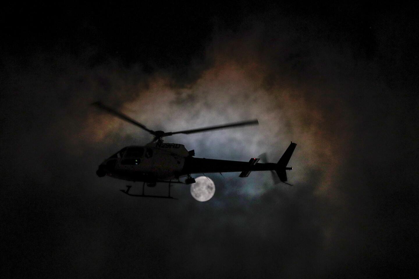 A helicopter circles above Budlong Avenue during Monday night's protest.