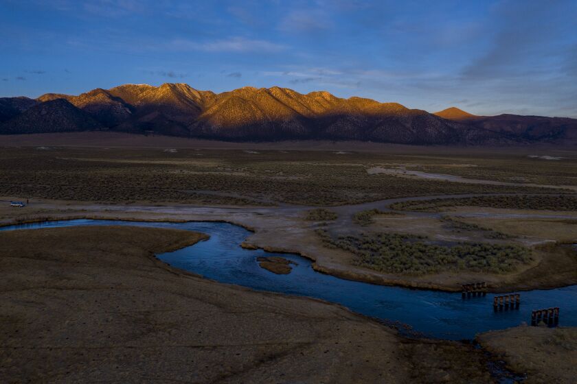 MAMMOTH LAKES, CA - JANUARY 13: The suns sets on the Glass Mountains and the Owens River overlooking Eastern Sierra Nevada wetlands and pastures near Mammoth Lakes on Wednesday, Jan. 13, 2021 in Mammoth Lakes, CA. For seven decades, LADWP has provided free allotments of water for irrigation purposes in the area and now they want to send the water south to Los Angeles instead. (Brian van der Brug / Los Angeles Times)