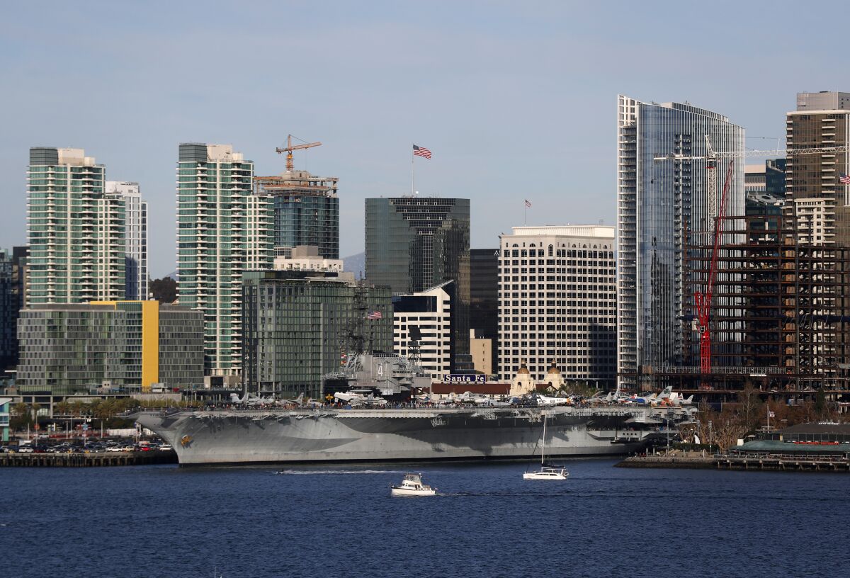 The USS Midway Museum is docked along the downtown San Diego waterfront, an iconic part of the city's skyline.
