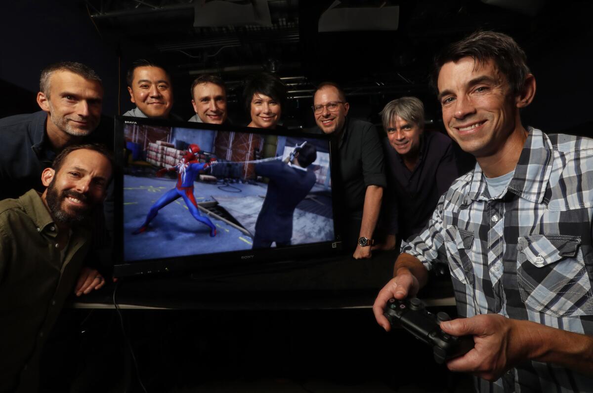 Insomniac Games CEO Ted Price, right, with from lower left, chief brand officer Ryan Schneider, chief architect Al Hastings, CFO Jen Huang, chief creative strategist Brian Hastings, chief people officer Carrie Dieterle, chief creative officer Chad Dezern and COO John Fiorito.