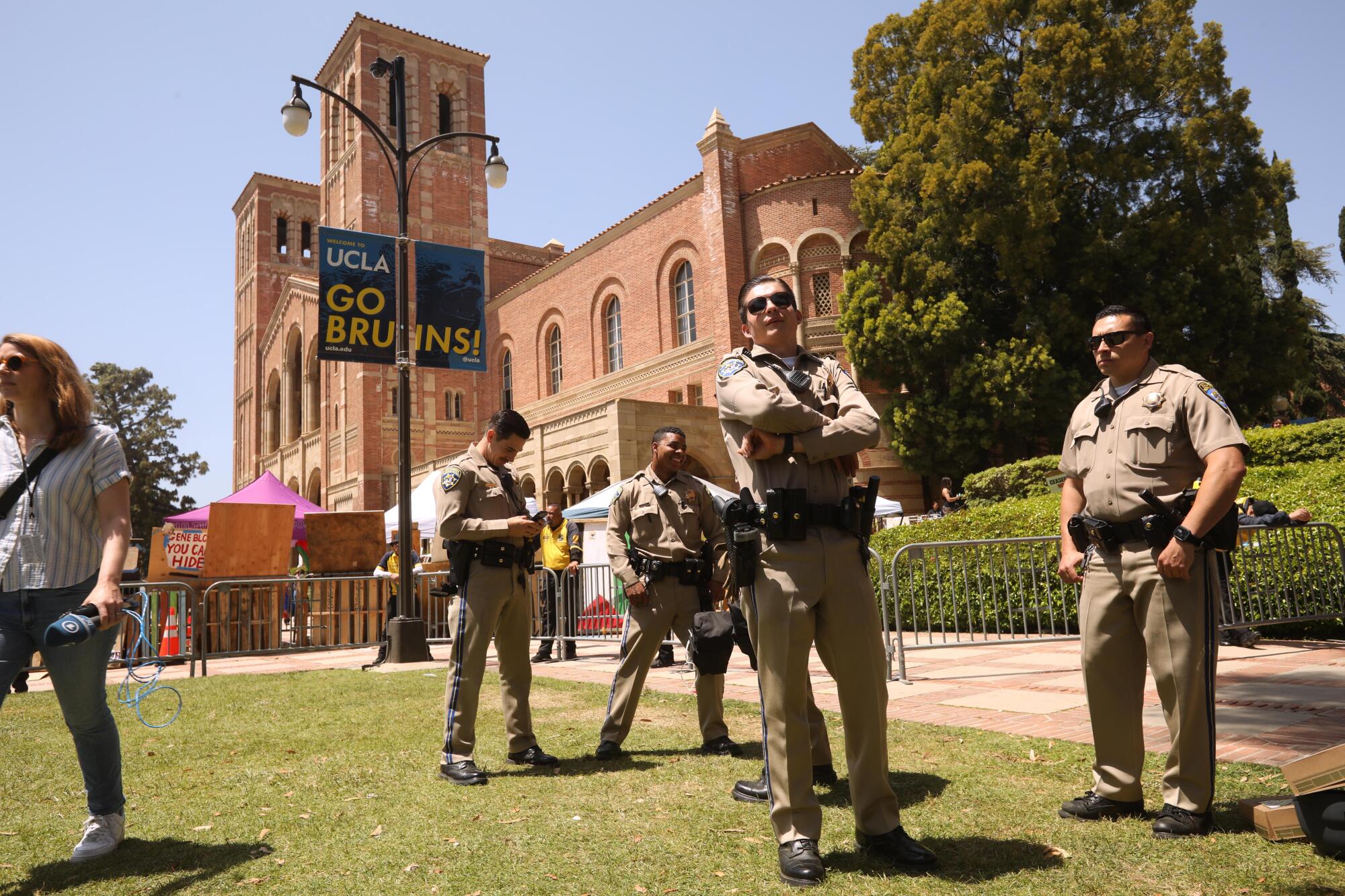 California Highway Patrol officers keep an eye on pro-Palestinian protesters near UCLA's Royce Hall.