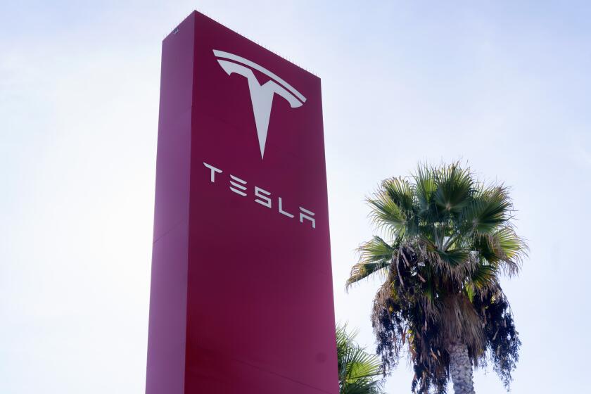 FILE - A Tesla sign is seen at Tesla in Buena Park, Calif. on Sunday Dec. 3, 2023. Tesla is recalling more than 3,000 of its 2024 Cybertrucks because of the possibility that a pedal can get stuck and cause the vehicle to accelerate unintentionally, increasing the risk of a crash. (AP Photo/Richard Vogel, File)