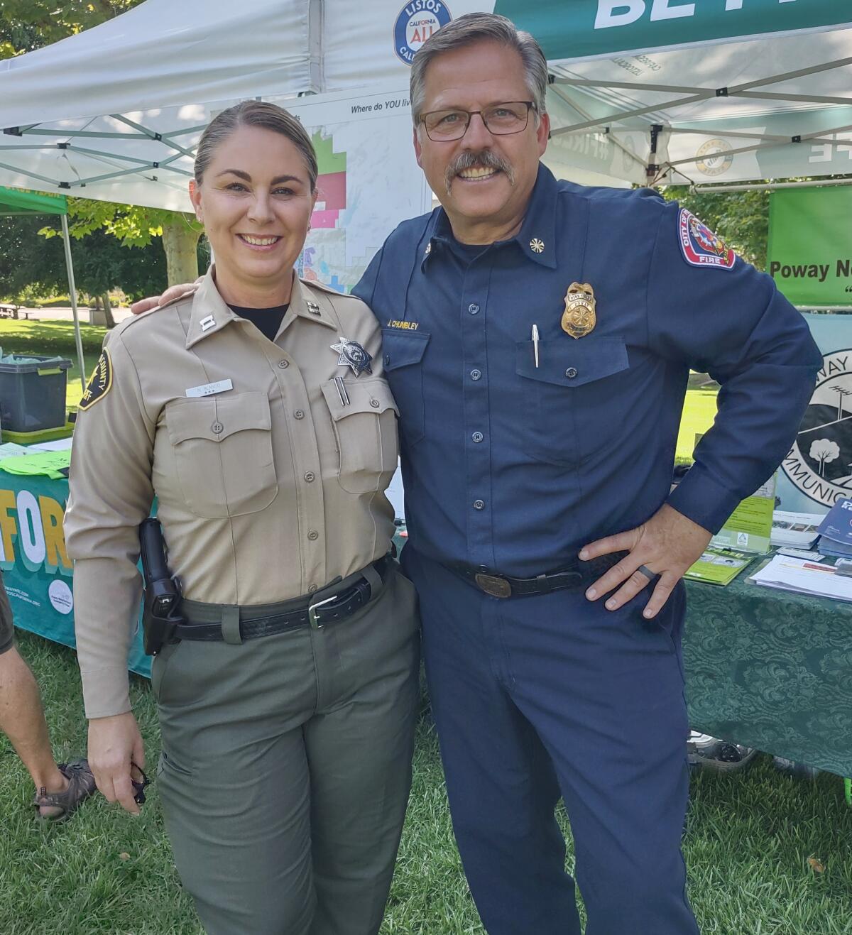 Poway Sheriff’s Capt. Nancy Blanco and Poway Fire Chief Jeff Chumbley greet visitors at National Night Out.
