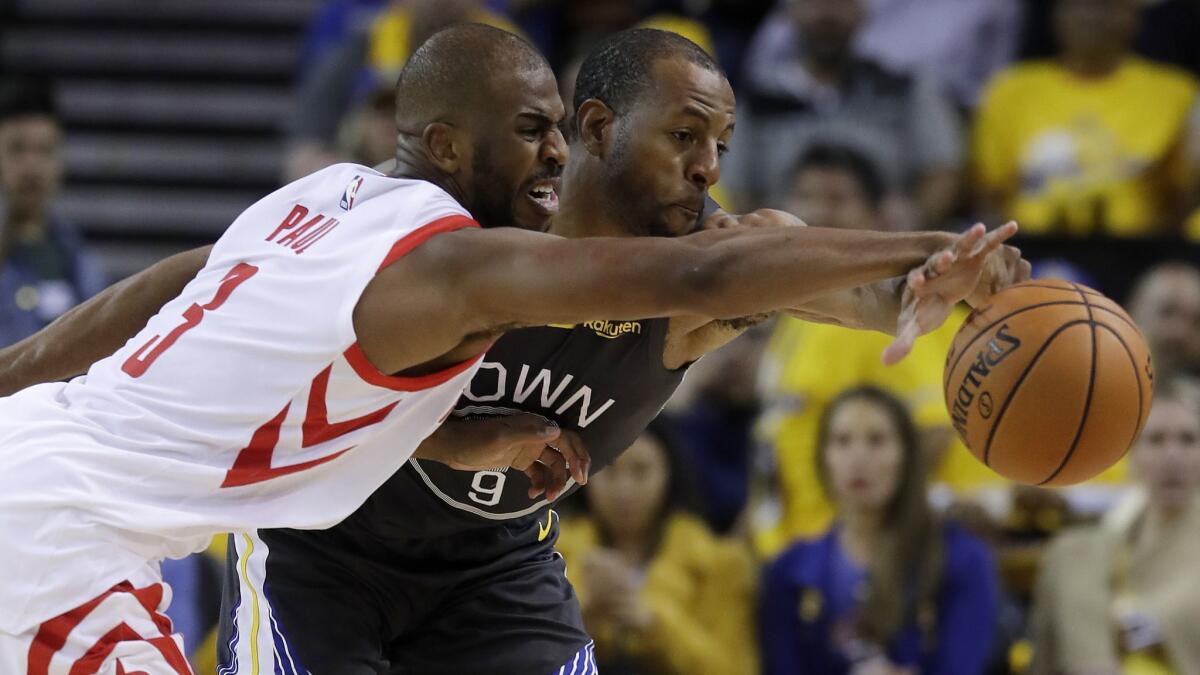 Golden State Warriors' Andre Iguodala, right, defends on Houston Rockets' Chris Paul during the second half in Game 2 of a second-round NBA playoff series in Oakland on Tuesday.