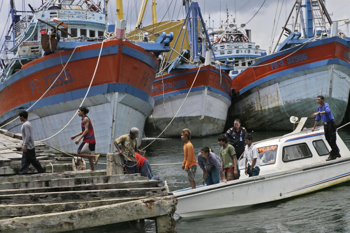 Burmese fishermen arrive at the compound of Pusaka Benjina Resources in Benjina, Aru Islands, Indonesia as hundreds of foreign fishermen rush at the chance to be rescued from the isolated island where slavery runs rampant in the industry.
